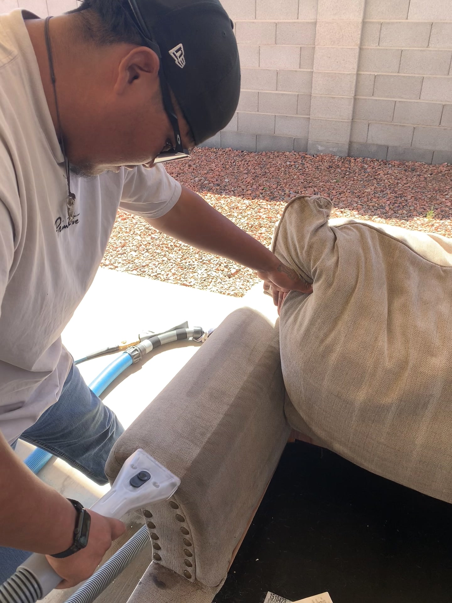 Technician using an upholstery extraction tool on a cushioned seat